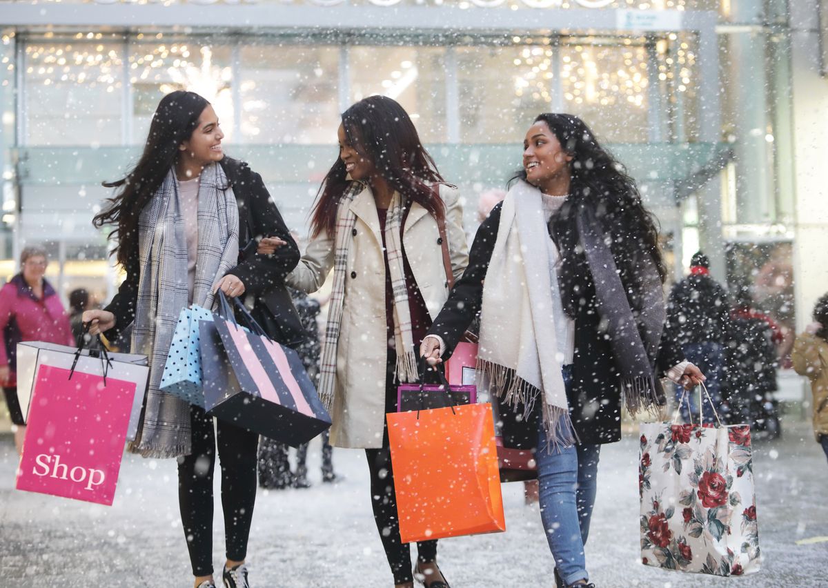 three young women in town shopping, in the snow