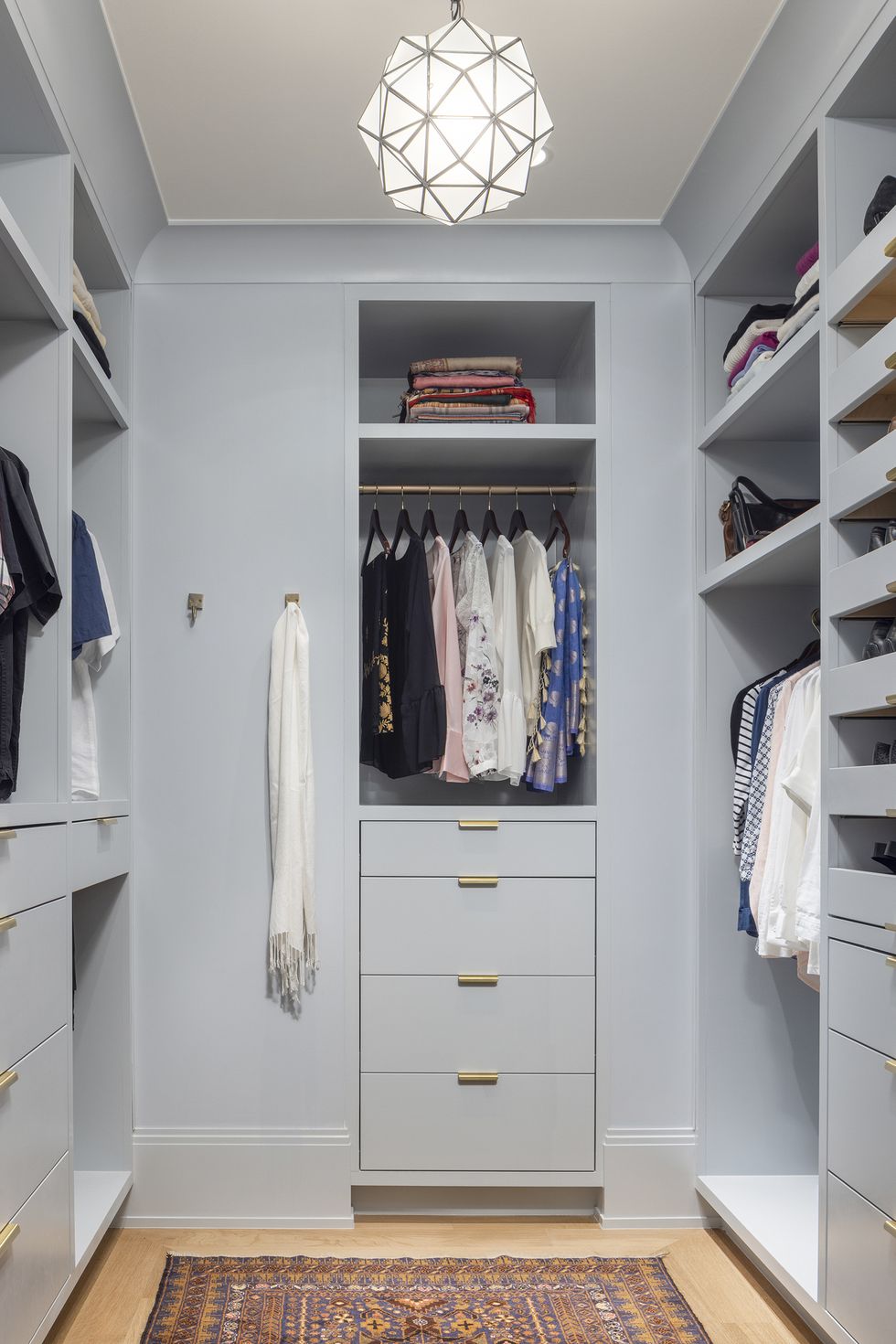 a closet with white shelves and light blue cabinets