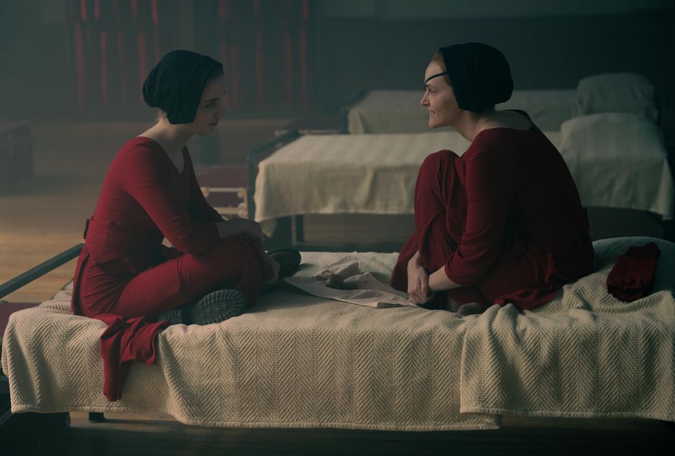 esther and janine sitting on a bed in the handmaids tale season 5