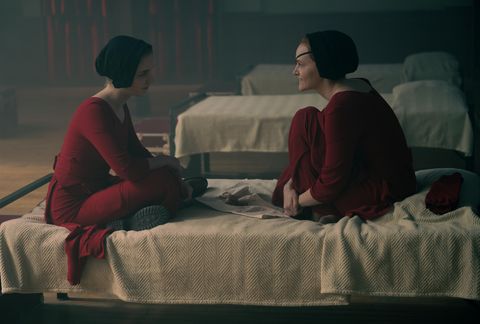 esther and janine sitting in bed in the story of the handmaids season 5