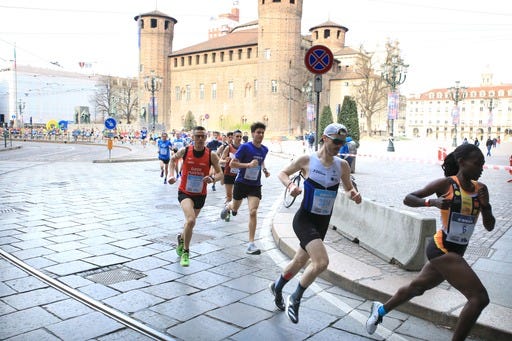 a group of people running on a street