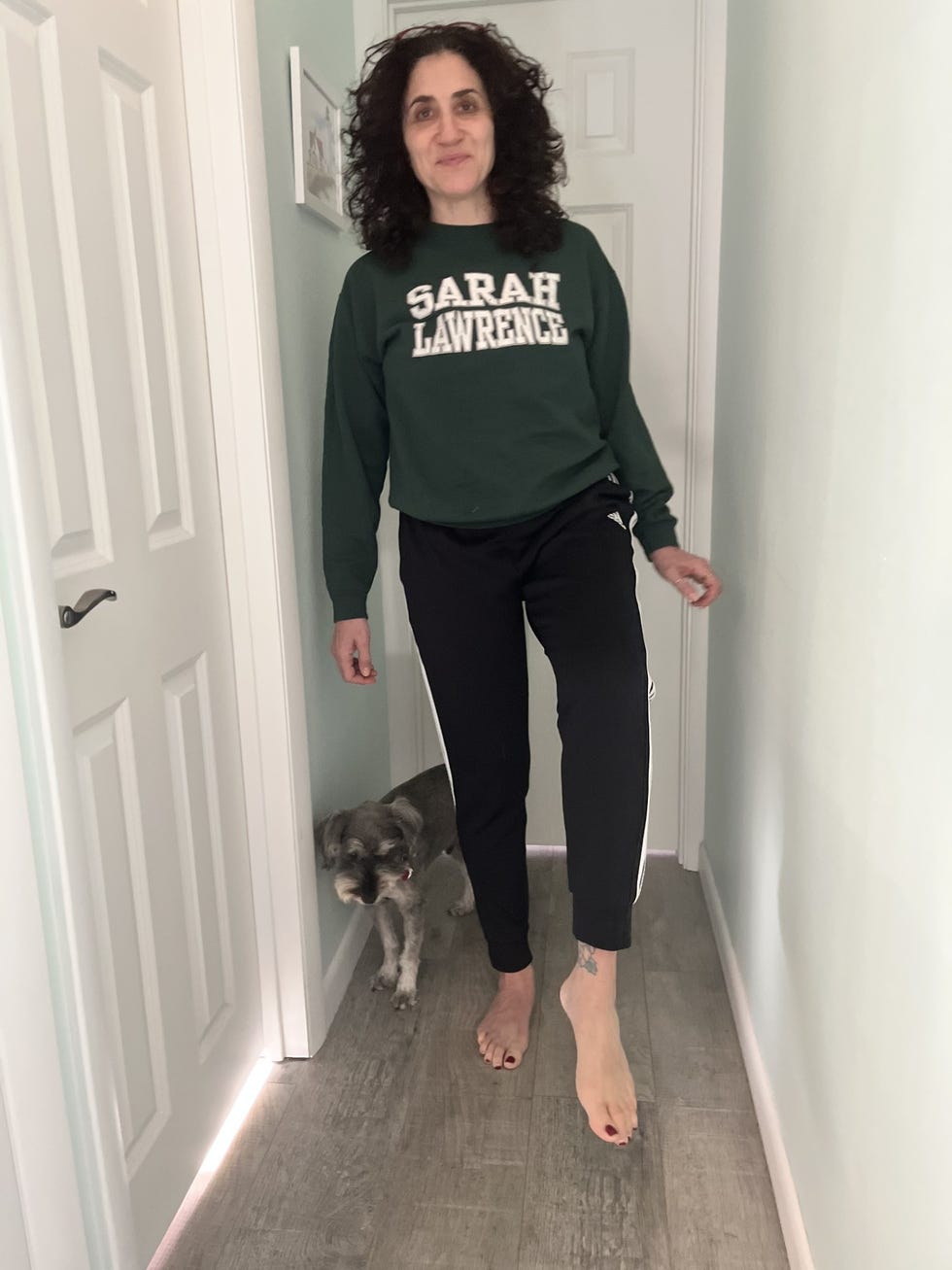 person walking through a hallway with a dog