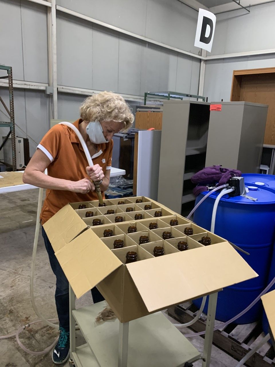 ann howard filling kombucha bottles with hand sanitizer to fight covid 19