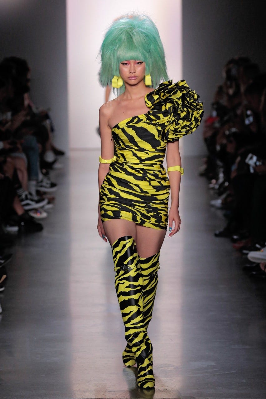 Fashion model, Fashion, Runway, Fashion show, Clothing, Shoulder, Yellow, Thigh, Footwear, Joint, 