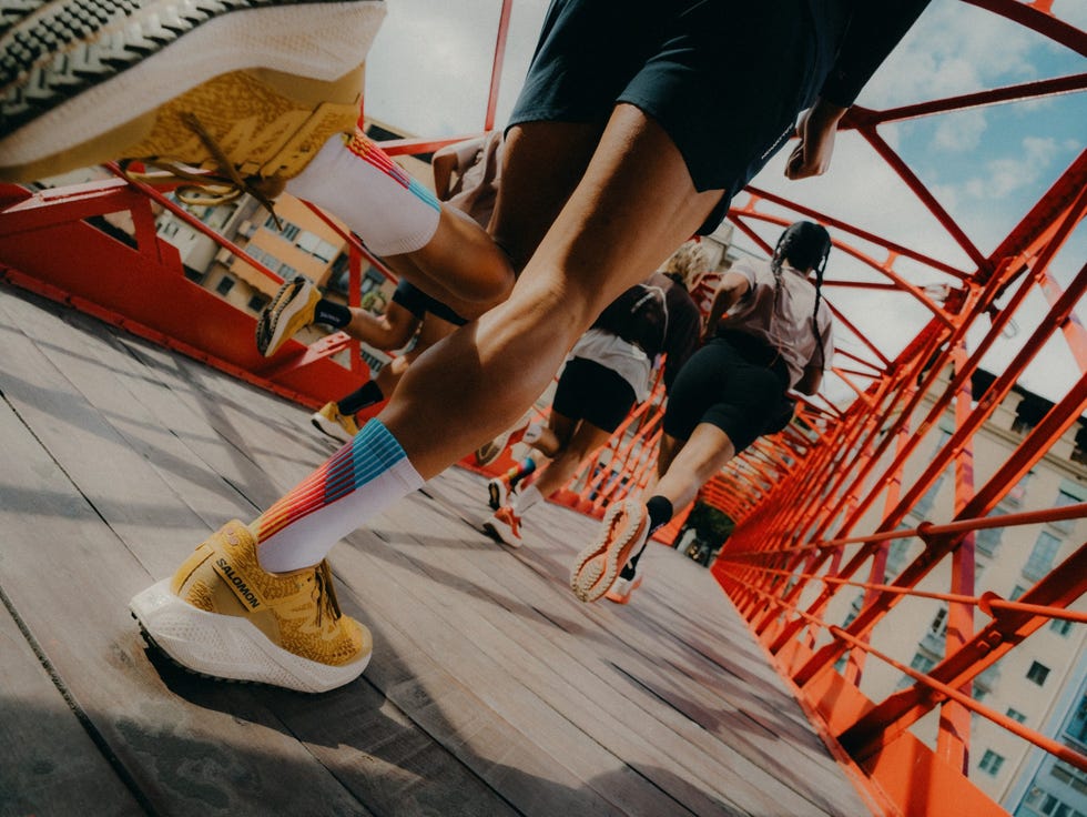 runners on a vibrant red bridge