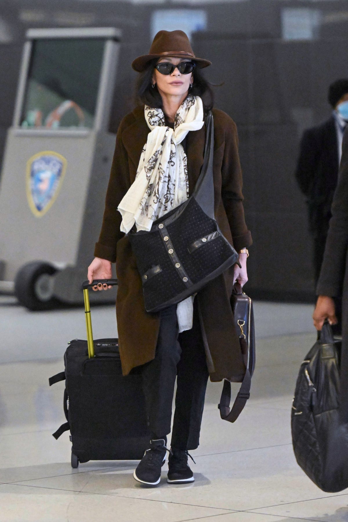 Catherine Zeta-Jones Is Elegant at the Airport in Chocolate-Brown Staples