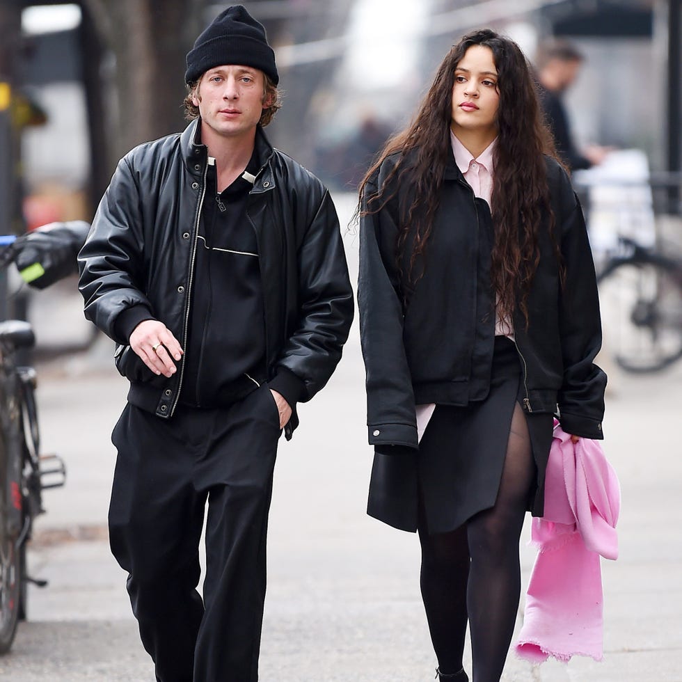 man and woman walking on the sidewalk