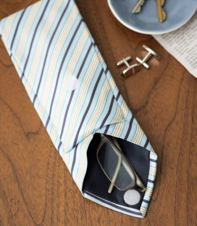 A glasses case made from a necktie on a brown table