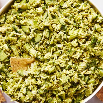 finely chopped green vegetables in a bowl with tortilla chips