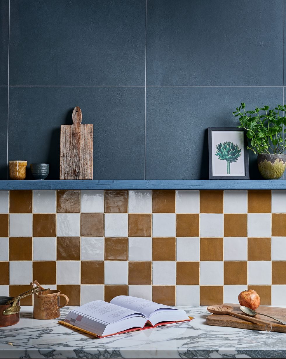 orange and white checkerboard wall tiles in a blue kitchen