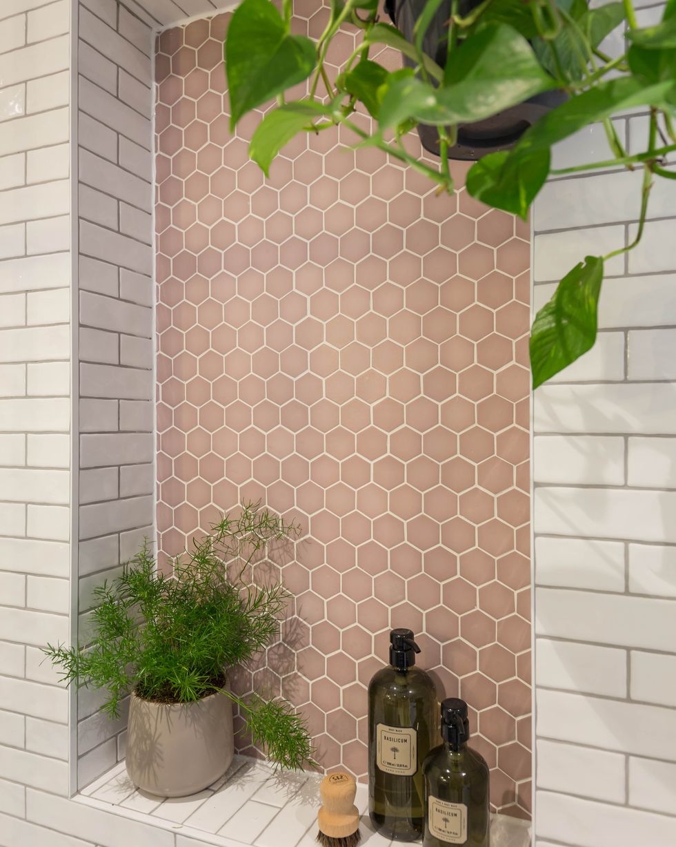 pink mosaic tiles in an alcove with brick tiles around