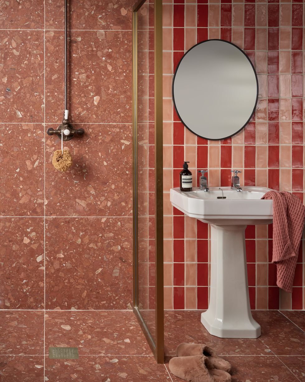 a small bathroom with large tiles and striped wall