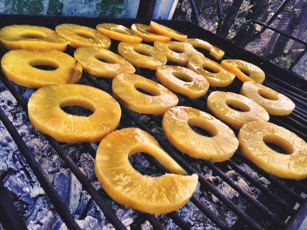 tilt shot of pineapple slices on barbecue grill