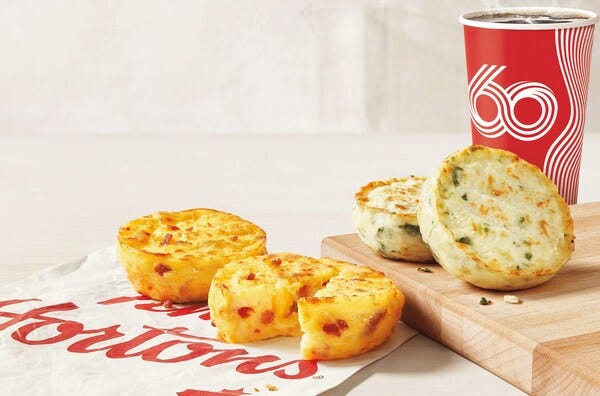 Plated breakfast items alongside a beverage cup