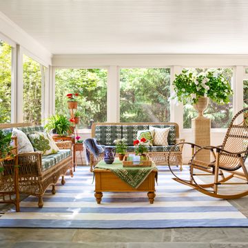 a sunroom with wicker furniture