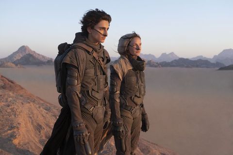 dune movie still showing paul atreides and his mother lady jessica standing in the desert on arrakis