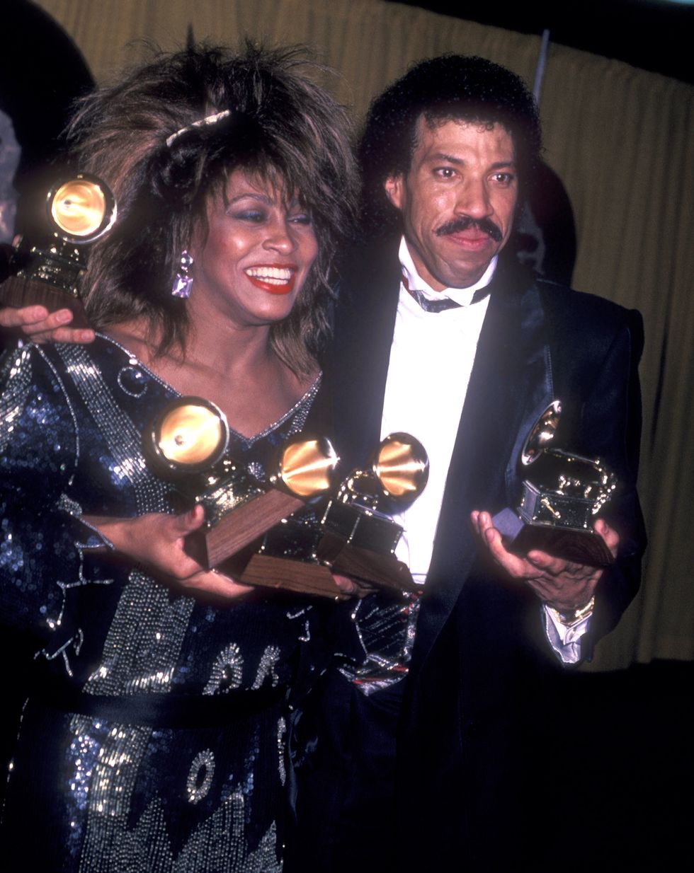 tina turner and lionel richie hold grammy trophies while standing together