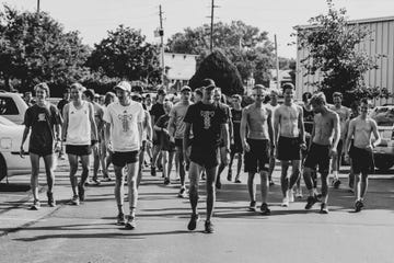 Reed Fischer and Brogan Austin lead a community run in Des Moines in July 2019.