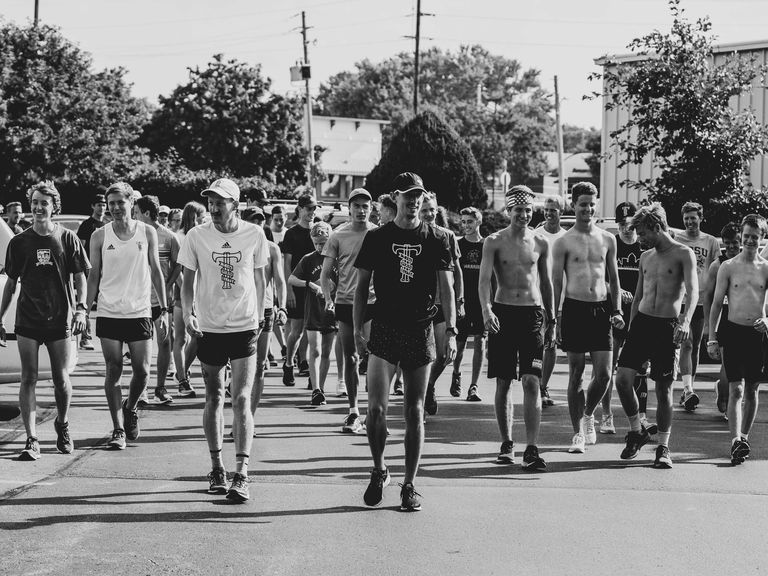 Reed Fischer and Brogan Austin lead a community run in Des Moines in July 2019.