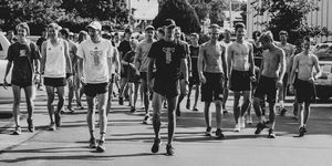 Reed Fischer and Brogan Austin lead a community run in Des Moines in July 2019.