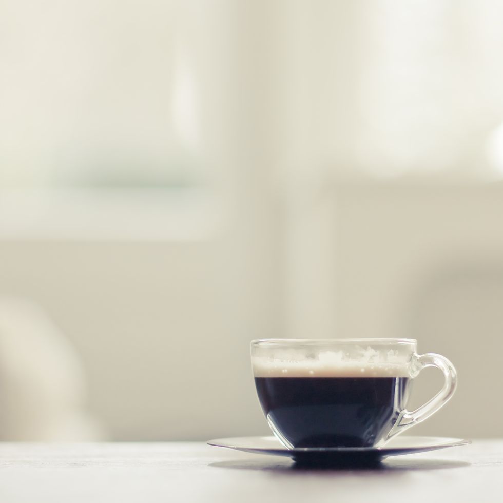 tiny glass cup of espresso coffee