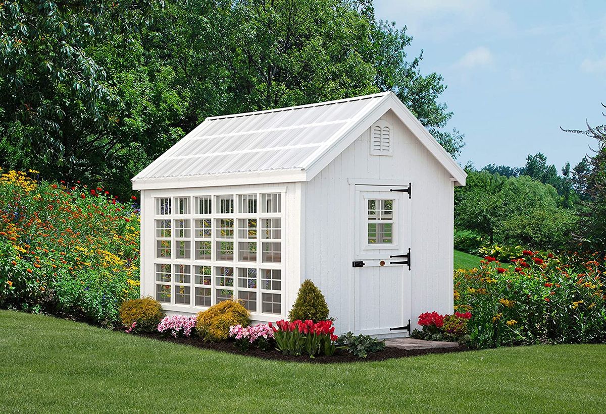 white garden shed with large windows and dutch door
