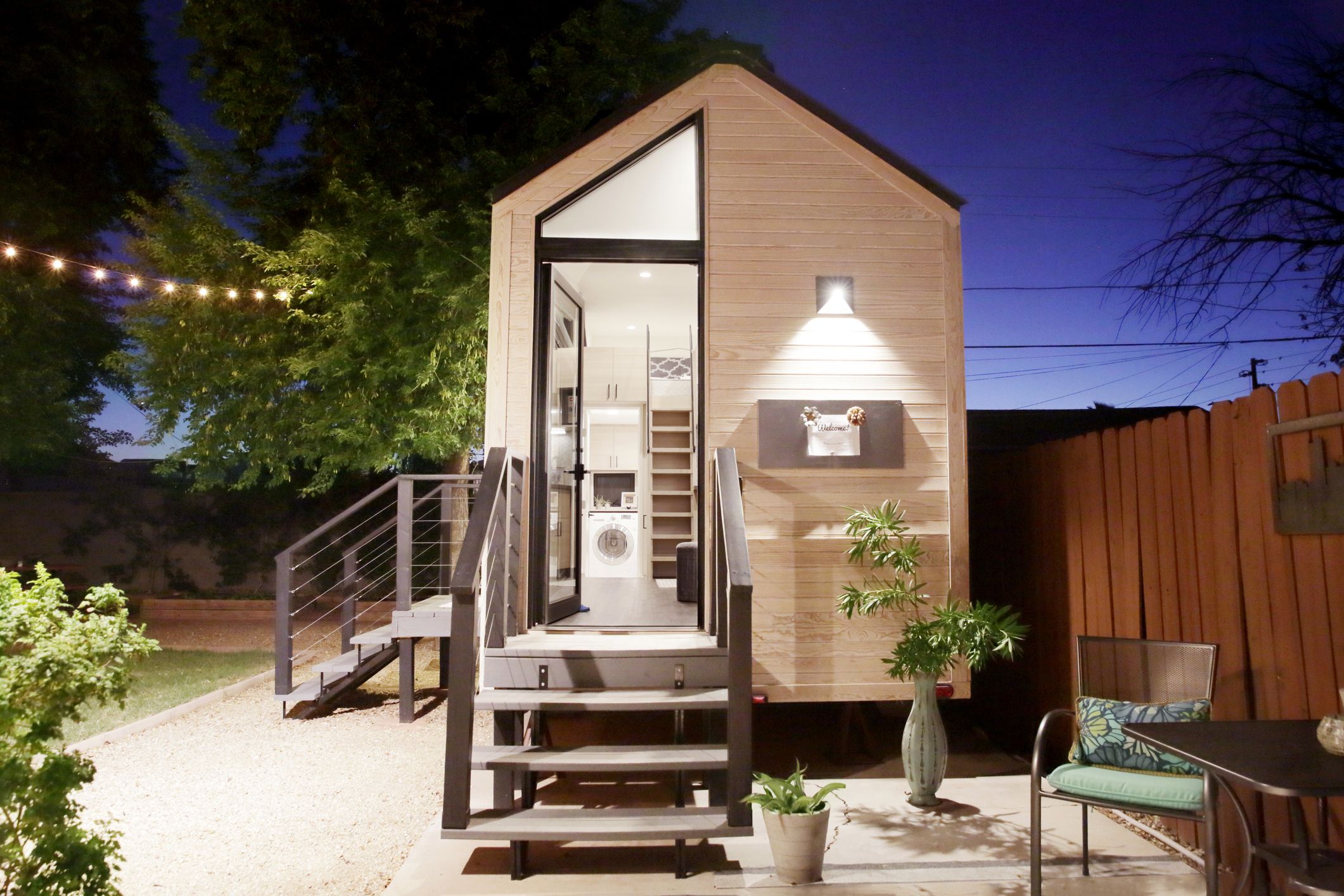 Rustic tiny house has a spacious interior and a balcony up top