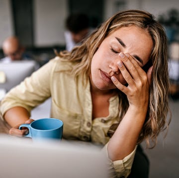 tired business woman rubbing eyes