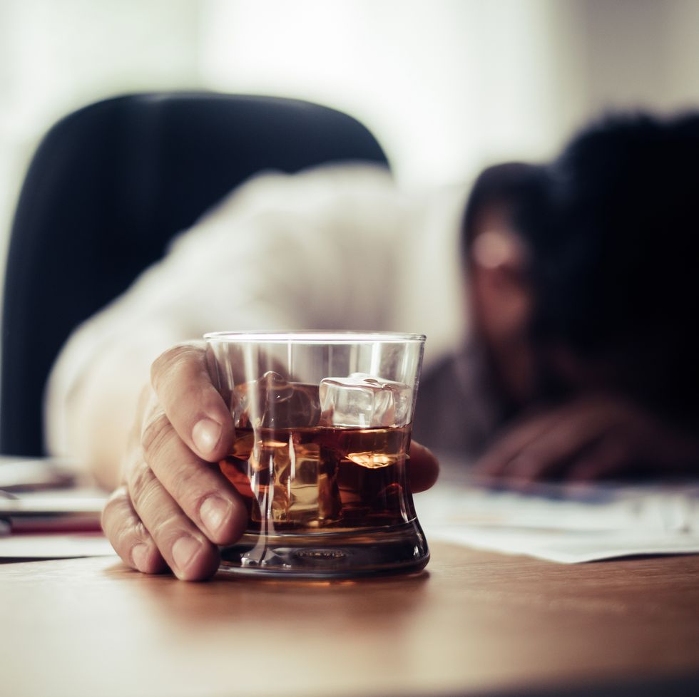 how to forgive yourself tired businessman holding whiskey glass on office desk