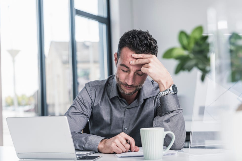 tired businessman sitting in office