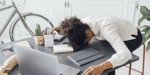 Tired freelancer sleeping on her deak