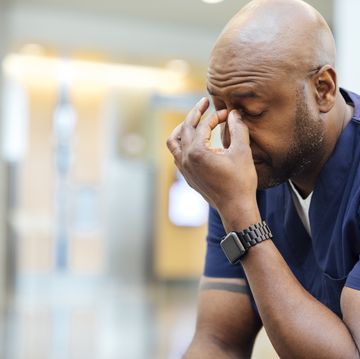 tired male nurse resting in hospital