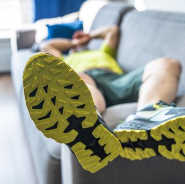 tired mature man resting on sofa after the morning workout