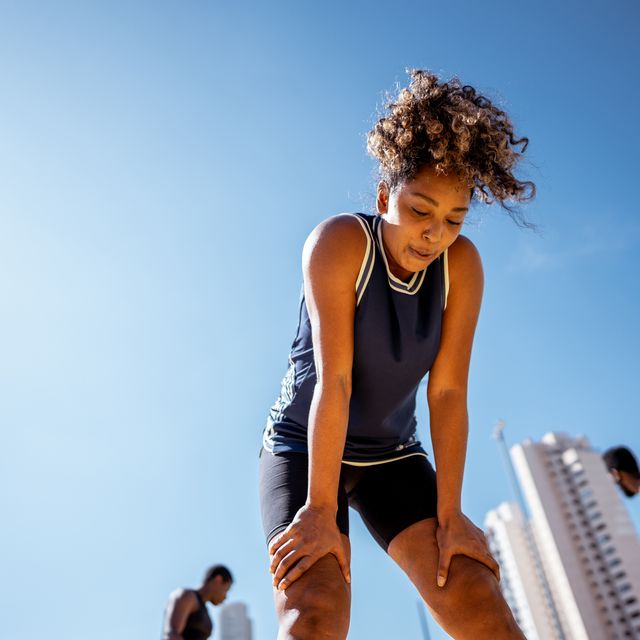 tired mid adult woman during exercises outdoors