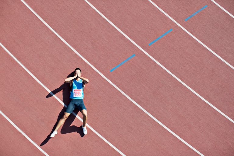 tired runner laying on track