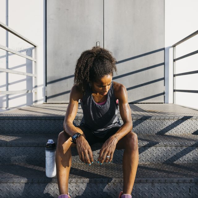 tired woman sitting and resting after workout