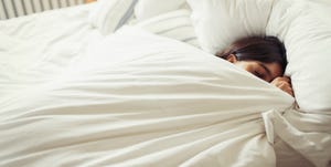 tired young woman sleeping in bed