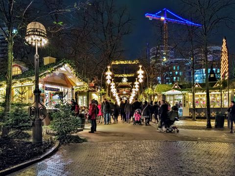 copenhagen, denmark   december 14, 2015 christmas market in tivoli gardens in dusk tivoli gardens is a famous amusement park and pleasure garden it is the most visited theme park in scandinavia