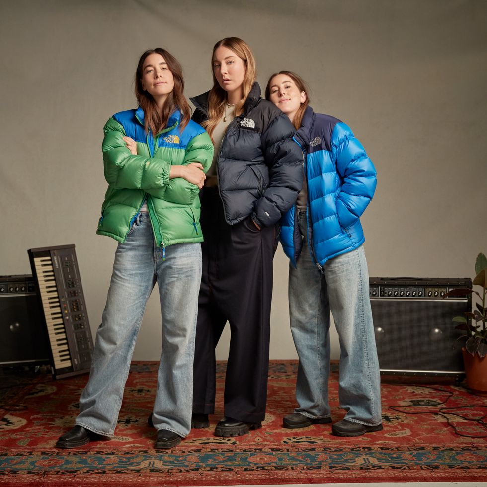 haim sisters standing in north face jackets