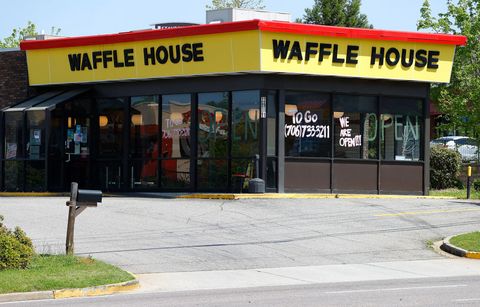 waffle house restaurant with signs indication the restaurant is open on the windows