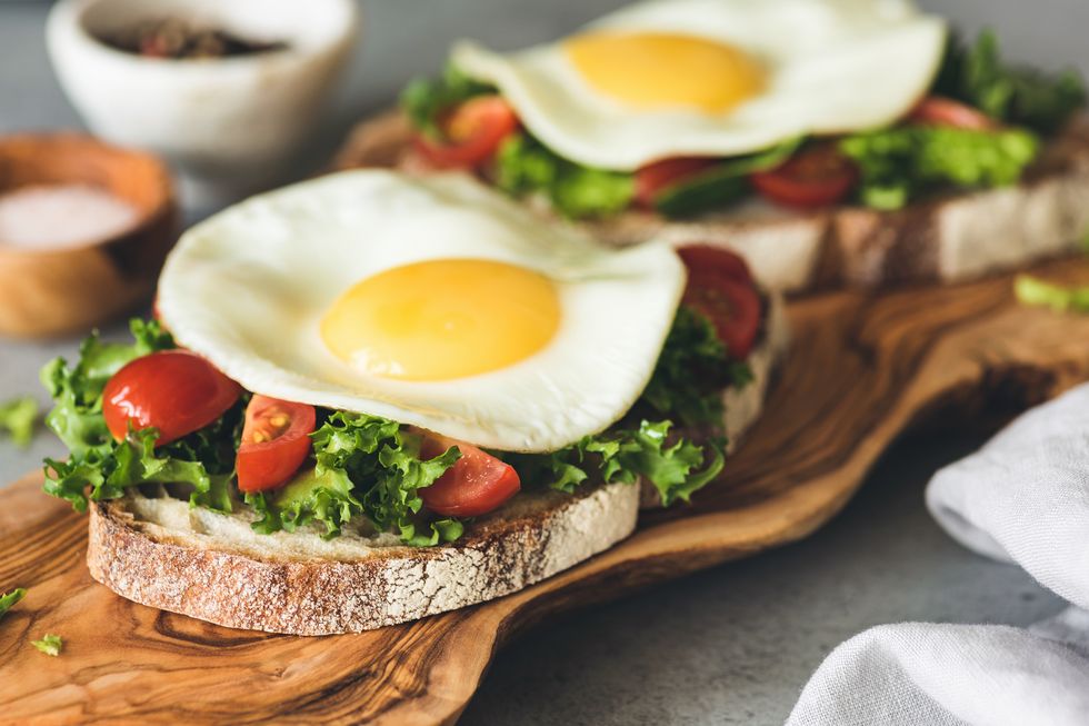 toast with salad, tomatoes and fried egg