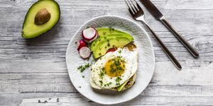 toast with with fried egg, avocado, red radish, tomato and cress