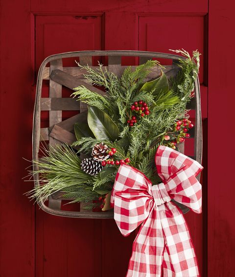 tobacco basket wreath with greenery, pine cones, and oversized bow