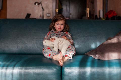 Toddler girl on couch in living room