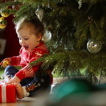 toddler girl with christmas tree
