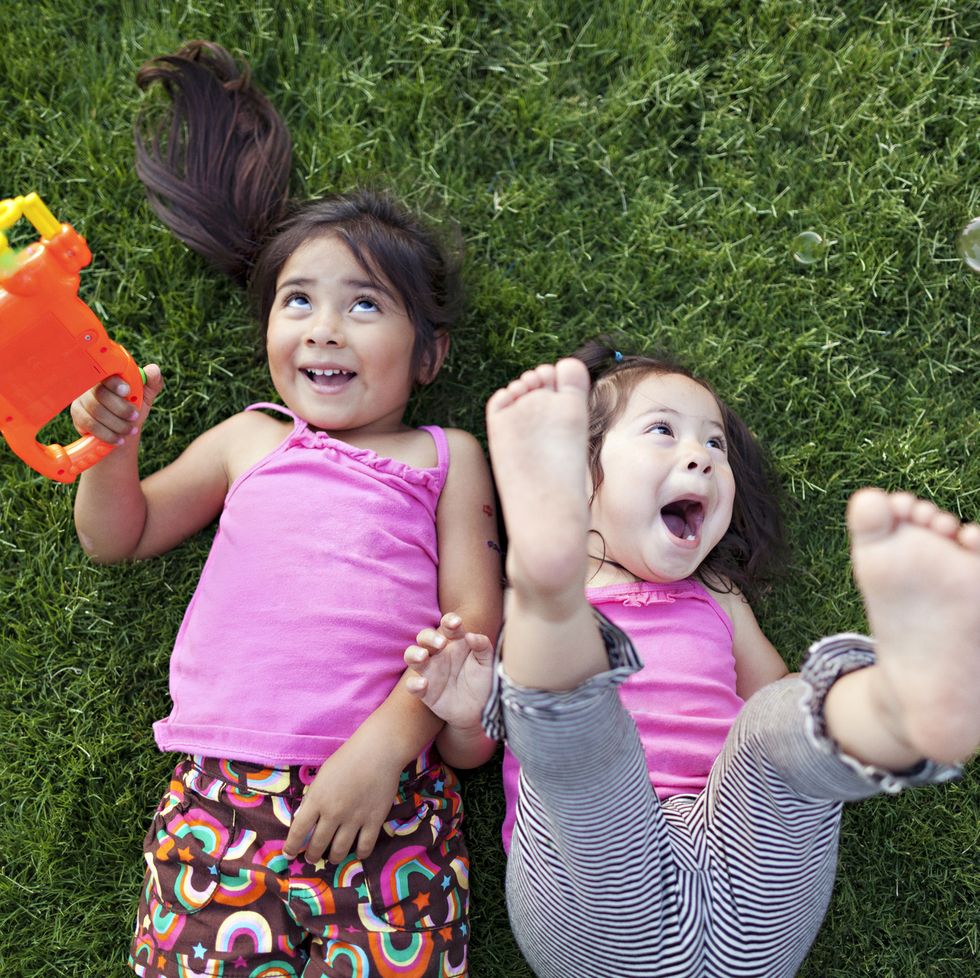 toddler girls playing with bubbles