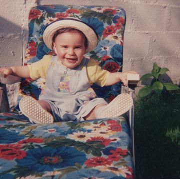 toddler laughing on a sunbed in summer 1990