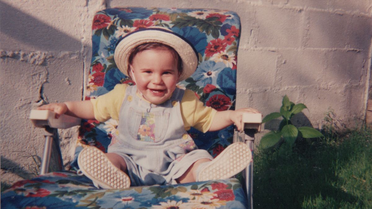 toddler laughing on a sunbed in summer 1990