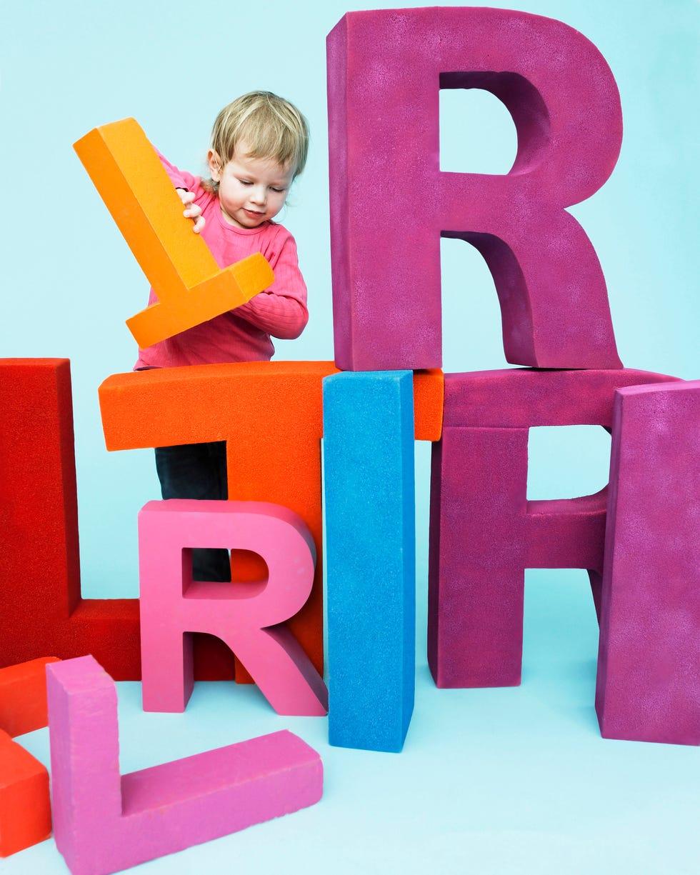 toddler playing with oversize letters