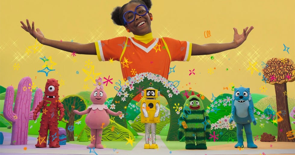 colorful scene featuring characters and a child with arms outstretched